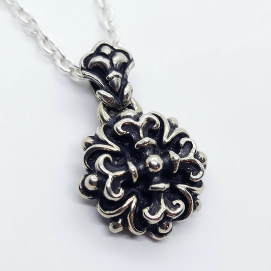 This Melodic Cross Pendant