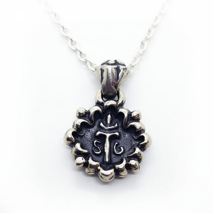 This Melodic Cross Pendant